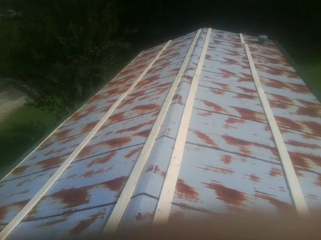Rusted metal roof panels with new wood purlins before replacement — Storm Damage Roof Repair in Sedgwick by Roofing Brothers