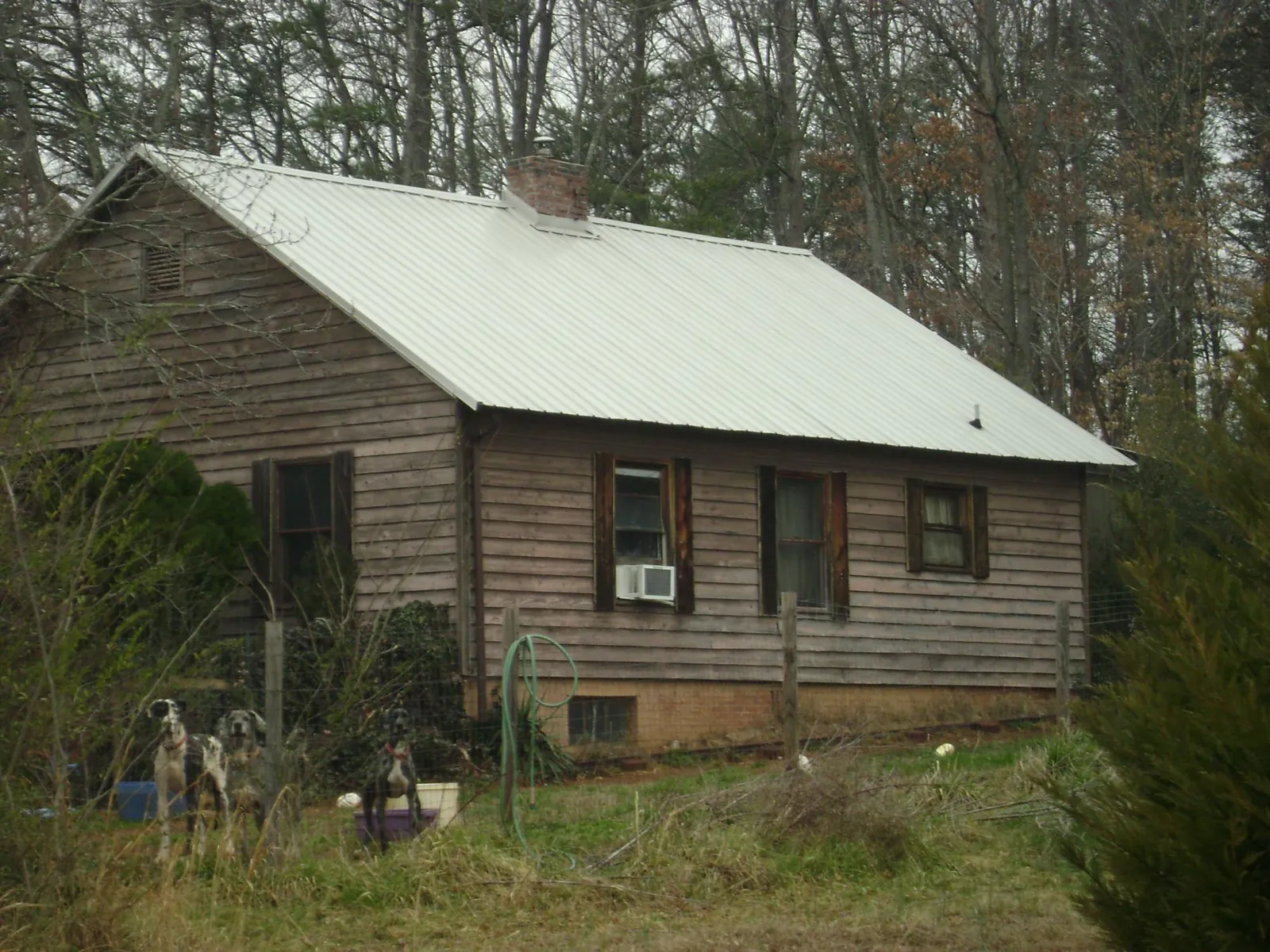 White metal roof on an old wood sided farmhouse, from a Metal Roof Installation job in Sedgwick